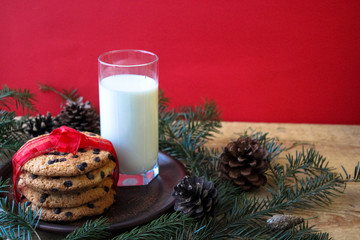 A glass of milk and cookies for Santa. Christmas Eve Concept.