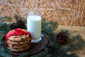A glass of milk and cookies for Santa. Christmas Eve Concept.