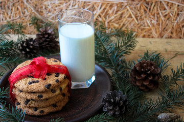 A glass of milk and cookies for Santa. Christmas Eve Concept.
