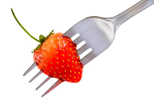Strawberry on fork isolated on white background which fresh juicy ripe red for dessert and food concept.