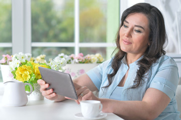 Close up portrait of beautiful woman using laptop at home