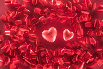 top view of two red hearts and beautiful decorative petals, valentines day background