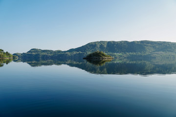 Norway beautiful spring landscape. Mountains reflection in calm water of fjord