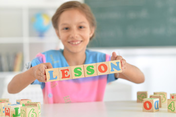 Close up portrait of cute little girl doing homework