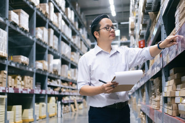 Warehouse worker checking goods at warehouse.