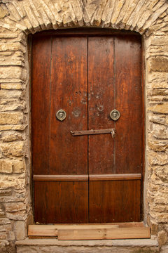 Medieval wooden door, adorned with stone