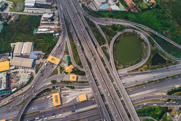 Transport junction circular city road aerial view with green tree