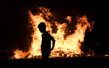 Little jewish religious boy do bonfire at Jewish holiday of Lag Baomer
