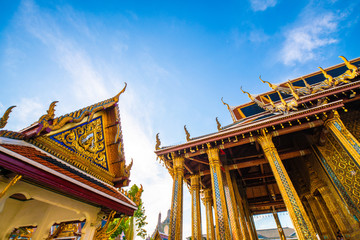 Fototapeta na wymiar Temple of the emerald buddha golden pagoda with blue sky cloud