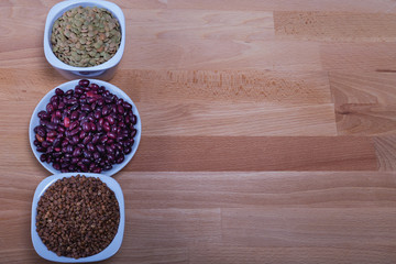 The concept of natural healthy food. Various grains of beans in white masks
