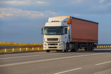 truck goes on highway on sunset