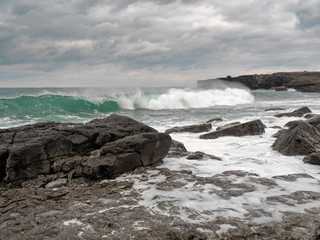Atlantic ocean, waves crushing on stone coast line. cloudy sky, West coast of Ireland. 