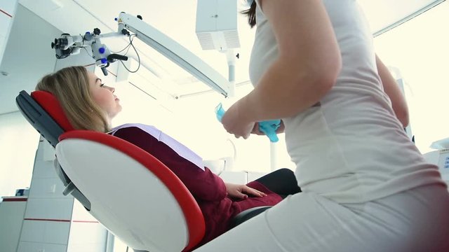 The dentist is preparing to examine the patient. Dental treatment