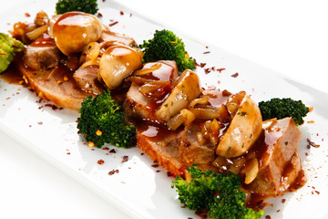 Grilled meat with broccoli and mushrooms on white background