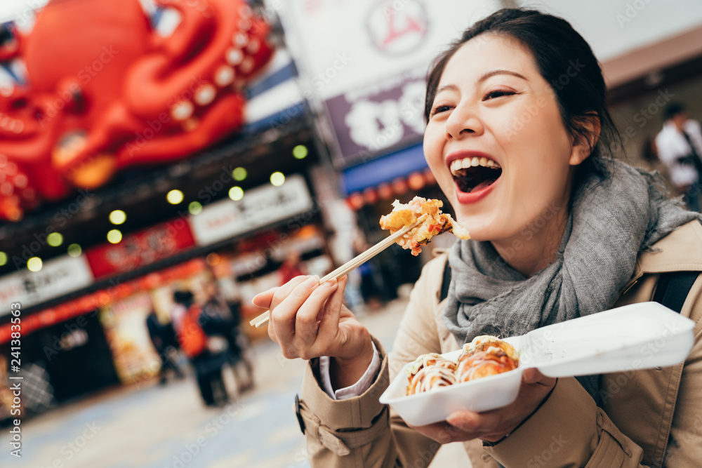 Wall mural woman holding box of japanese local street food.