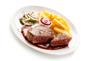Grilled beefsteak with french fries and vegetable salad on white background