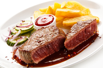 Grilled beefsteak with french fries and vegetable salad on white background