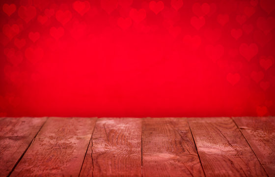 Wooden table bokeh heart red background