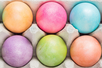 Fototapeta na wymiar Multicolored easter eggs in a box. Top view