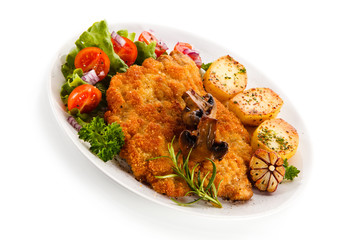 Fried pork chop with potatoes on white background