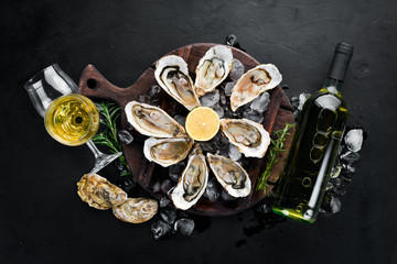 Fresh oysters with ice and white wine. Seafood. Top view. Free copy space. © Yaruniv-Studio