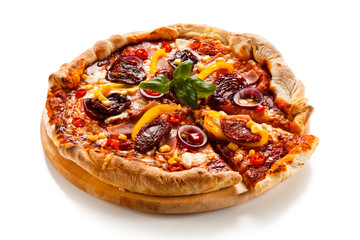 Pizza with ham, corn, mushrooms and dried tomatoes on white background