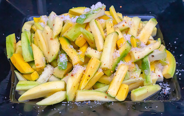 Mango cut into small pieces, sprinkle with salt, pepper and sugar.