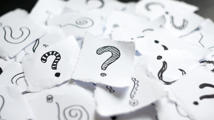 Many question marks on white papers. Doodle drawn question marks on scraps of paper. Choice,...