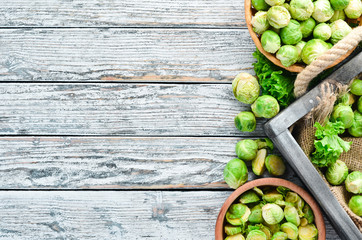 Brussels cabbage on a white wooden background. Vegetables. Top view. Free space for your text.