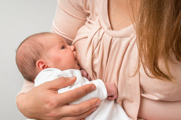 Mother is breastfeeding her newborn baby