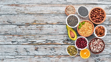 Superfoods Healthy food. Nuts, berries, fruits, and legumes. On a white wooden background. Top view. Free copy space.