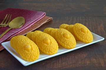Thai dessert / Royal Thai cuisine : Golden sweetmeat  (Kha nom Thong Ek) , one of famous nine auspicious desserts in Thai tradition, made from yolk, wheat flour and edible gold. Copy space