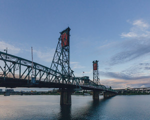 Hawthorne Bridge over Willamette River at sunset in downtown Portland, USA