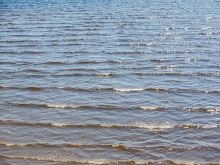 sandbank on the river. waves and clear water near the shore