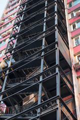 Metal fire escape of high building. Close-up. Vertical image