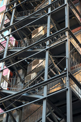 Fototapeta premium Metal fire escape of high building. Close-up view. Vertical image