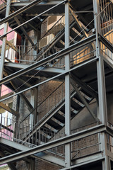 Fototapeta premium Metal construction of fire escape. Close-up. Vertical image