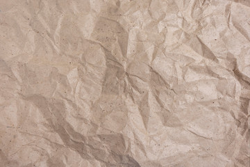 Background of crumpled wrapping paper. Rumpled paper texture