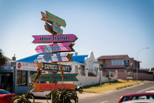 Colorful wooden direction sign in Jeffreys Bay town, South Africa