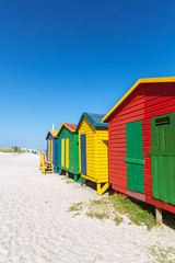 Naklejka premium Muizenberg beach with white sand and colorful wooden cabins in Cape Town, South Africa