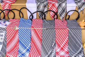 Different keffiyeh (traditional arabian headdress) for sale in a street shop