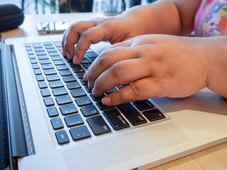 close up hands are typing on a laptop computer