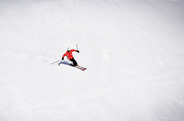 Naklejka na ściany i meble Skier skiing downhill during sunny day in high mountains. Italy, Europe.