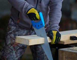 Woodworker using hand saw