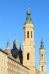 A landscape of a bell tower of the Pilar Cathedral during a sunny summer day in Zaragoza, Spain