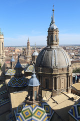 The christian Pilar Cathedral (Catedral del Pilar) bell towers and central dome, with colored tiles, in summer, in Zaragoza, Aragon region, Spain
