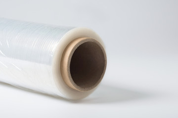 A roll of a clear polyethylene sheeting at the white background.