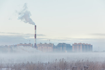 urban buildings in the fog on an early winter morning