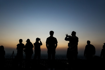 Silhouettes group of people taking pictures at sunset in Nahagarh Fort Jaipur.