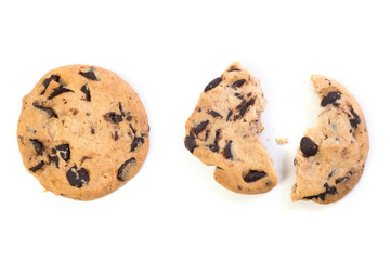 Broken chocolate cookies at the white background. A view from above.